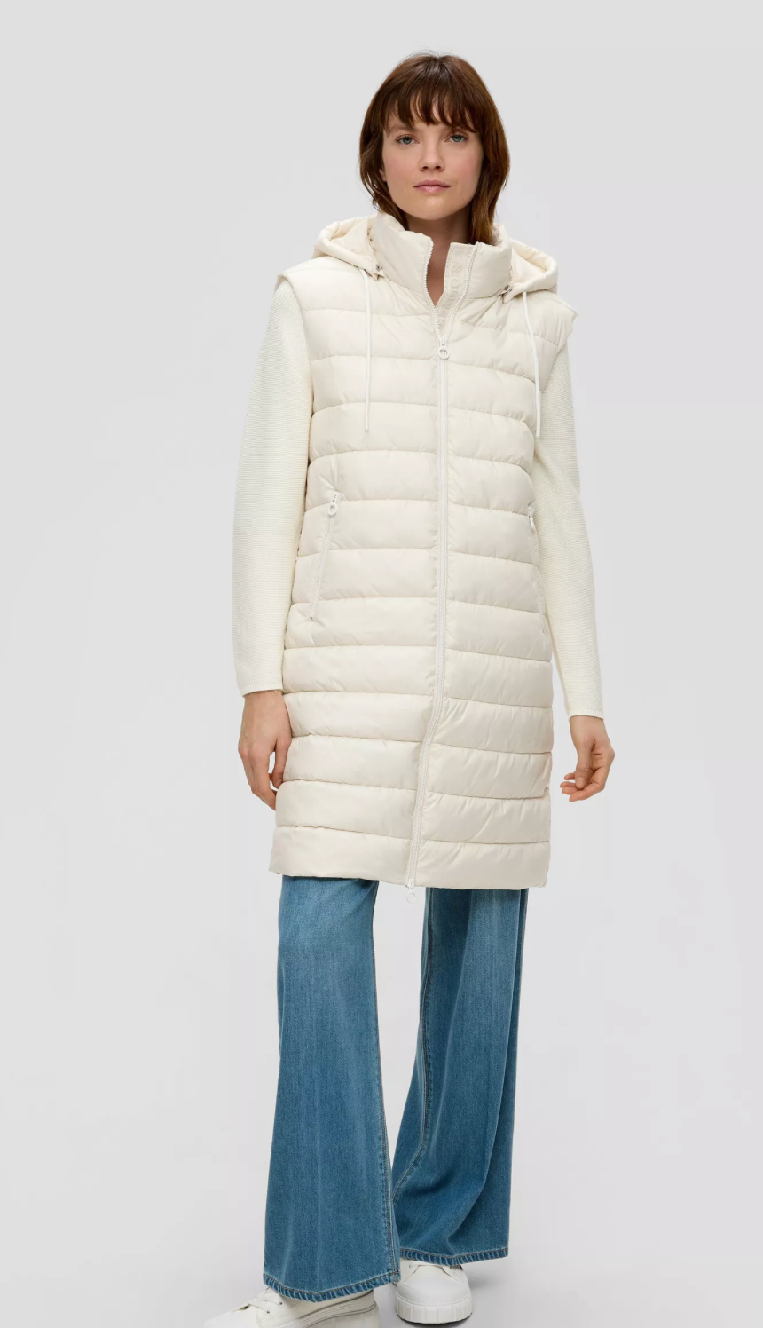 Long quilted body warmer with a detachable hood